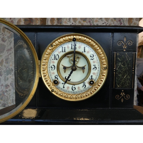 102 - An early/mid 20thC black painted metal cased mantel clock; the movement faced by an Arabic dial, on ... 