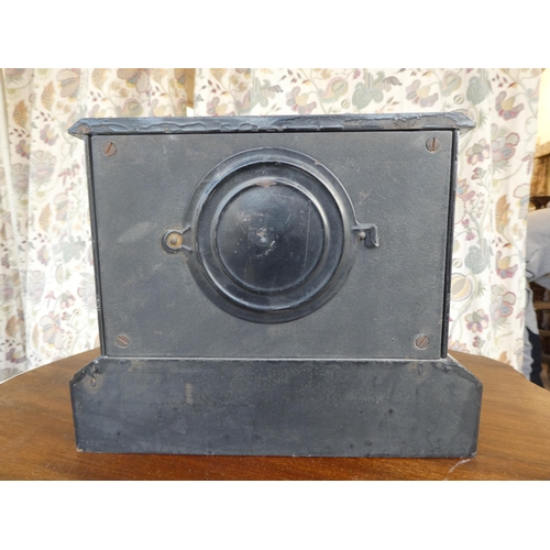 102 - An early/mid 20thC black painted metal cased mantel clock; the movement faced by an Arabic dial, on ... 