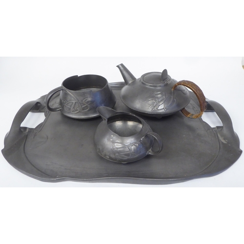 105 - A Liberty & Co Tudric pewter three piece tea set of squat, bulbous form, designed by Archibald K... 