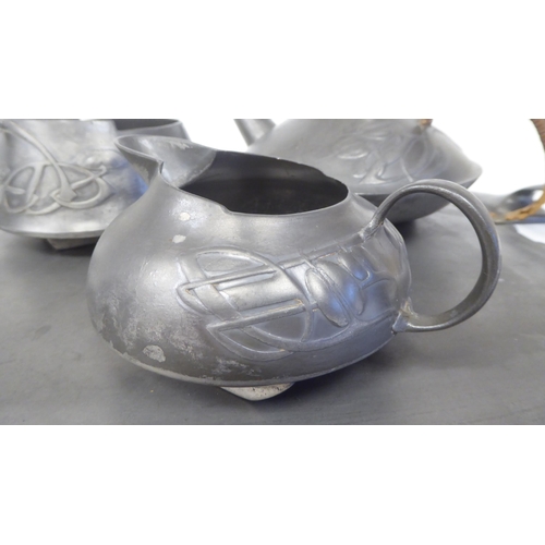 105 - A Liberty & Co Tudric pewter three piece tea set of squat, bulbous form, designed by Archibald K... 