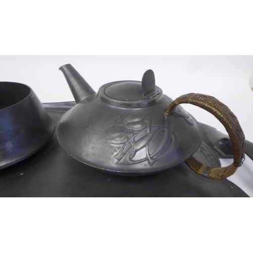 105 - A Liberty & Co Tudric pewter three piece tea set of squat, bulbous form, designed by Archibald K... 