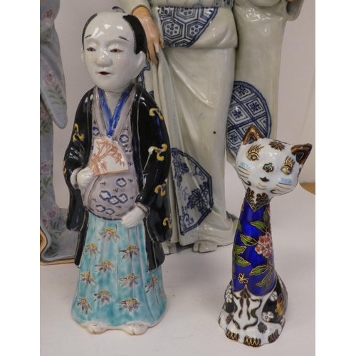 113 - Modern Oriental ceramics: to include figures wearing traditional robes  largest 19