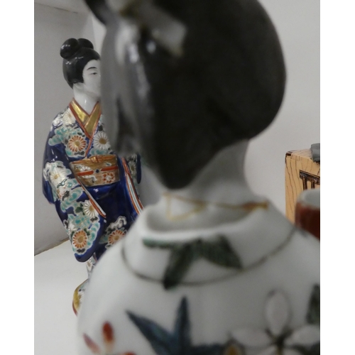 113 - Modern Oriental ceramics: to include figures wearing traditional robes  largest 19