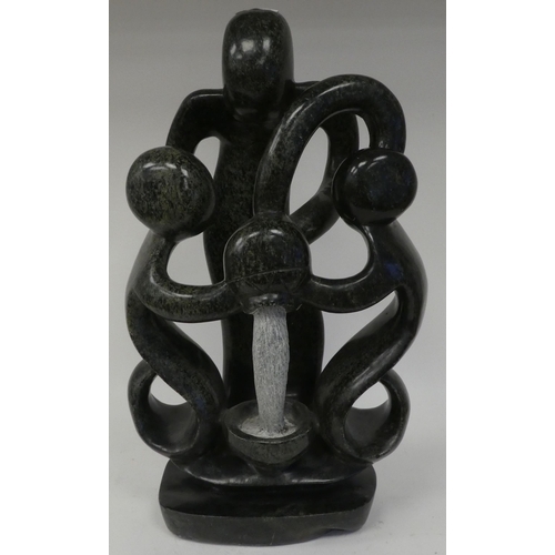 127 - A modern hardstone abstract sculpture, three figures with a pouring vessel  19