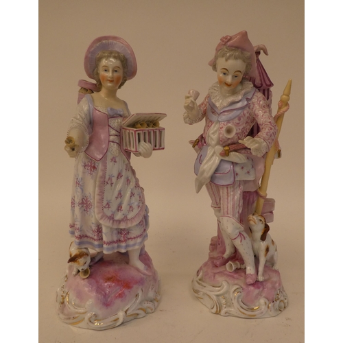 132 - A pair of 20thC Continental porcelain figures, one an itinerant entertainer wearing a tricorn hat, t... 