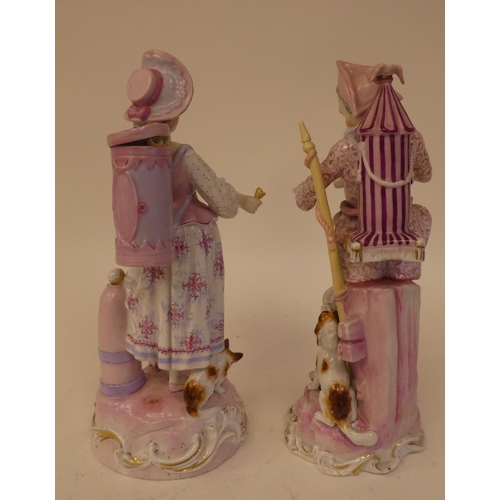 132 - A pair of 20thC Continental porcelain figures, one an itinerant entertainer wearing a tricorn hat, t... 