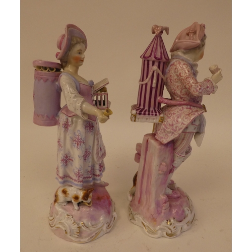 132 - A pair of 20thC Continental porcelain figures, one an itinerant entertainer wearing a tricorn hat, t... 