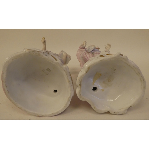 132 - A pair of 20thC Continental porcelain figures, one an itinerant entertainer wearing a tricorn hat, t... 