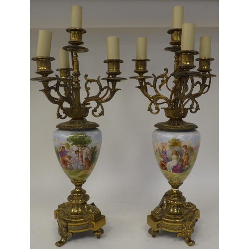 147 - A pair of 20thC decoratively cast brass and painted ovoid shape ceramic table lamps, each comprising... 