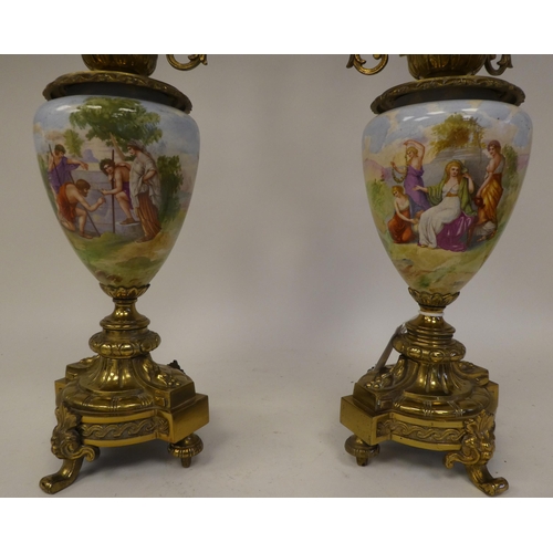 147 - A pair of 20thC decoratively cast brass and painted ovoid shape ceramic table lamps, each comprising... 