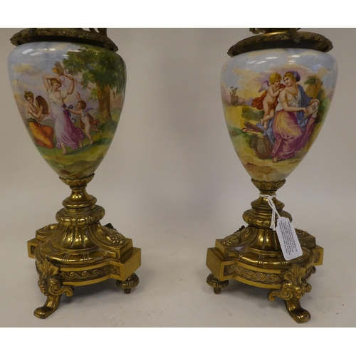 147 - A pair of 20thC decoratively cast brass and painted ovoid shape ceramic table lamps, each comprising... 