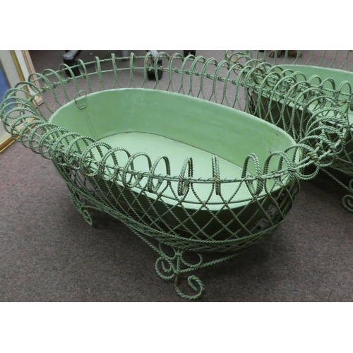 149 - A pair of vintage oval green wirework planters with tinplate liners, elevated on scrolled feet  26