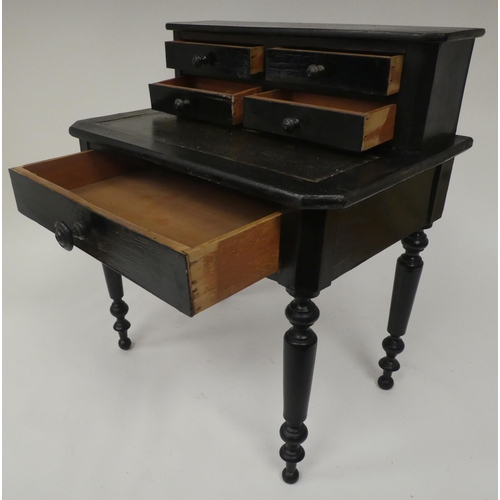 179 - A late 19thC ebonised pine apprentice piece, bonheur du jour with a drawer fitted superstructure, ra... 