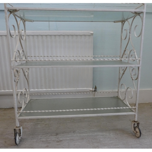 A 1970/80s white painted, cast metal, three tier hostess trolley with ...