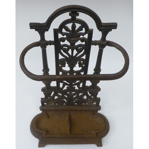 27 - A late Victorian cast iron stickstand, the pierced upstand decorated with vase and floral ornament, ... 