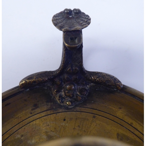 4 - A Victorian brass chamberstick with a coiled snake handle and shell cast tab  bears a Queen Vic... 