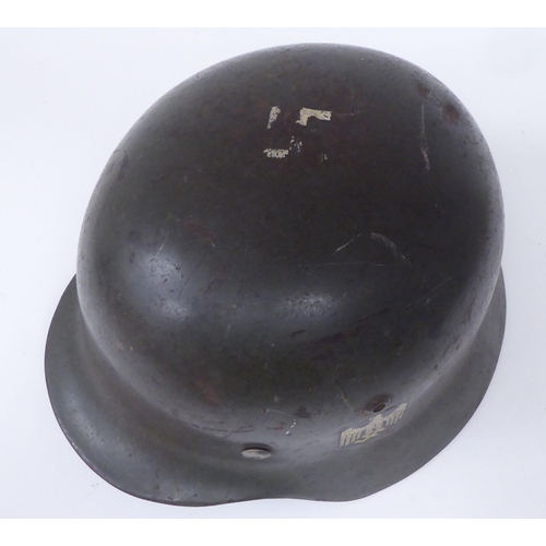 52 - World War II era militaria: to include a khaki coloured German steel helmet with a hide liner and de... 