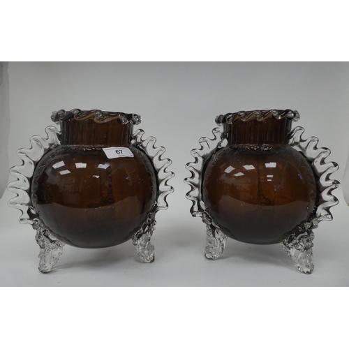 67 - A pair of semi-opaque aubergine coloured and clear glass, globular vases, in the manner of Whitefria... 