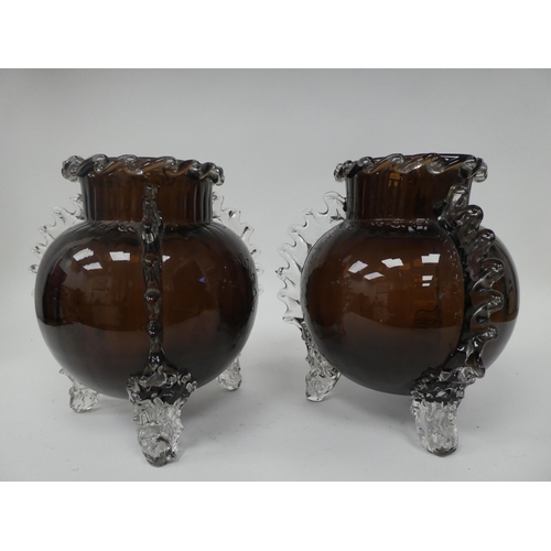 67 - A pair of semi-opaque aubergine coloured and clear glass, globular vases, in the manner of Whitefria... 