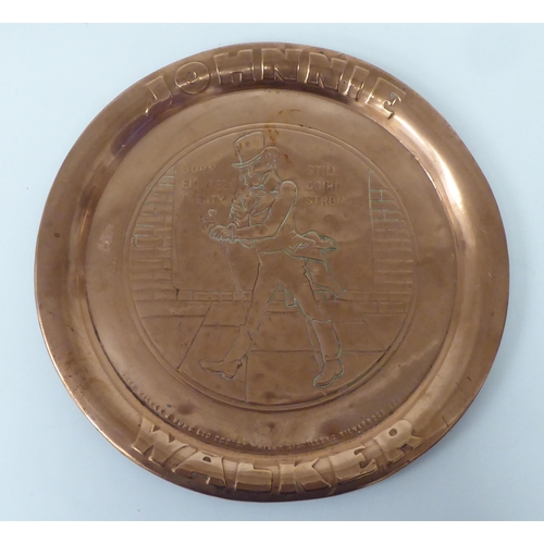 7 - A John Walker & Sons 'Johnnie Walker' promotional copper tray  bears an impressed image of the g... 