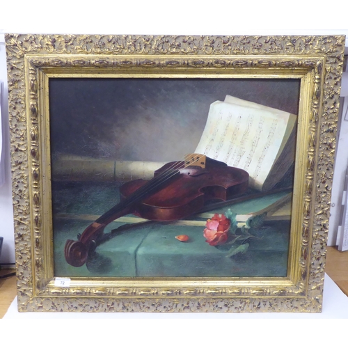 72 - 20thC European School - a still life study, a violin and sheet music  oil on canvas  bears... 