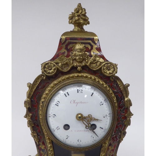 81 - A 19thC French red boulle cased mantel clock of waisted form with gilt metal mounts; the bell strike... 