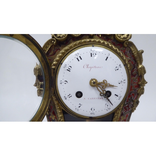 81 - A 19thC French red boulle cased mantel clock of waisted form with gilt metal mounts; the bell strike... 