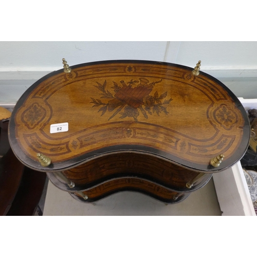 82 - An early 20thC overpainted mahogany kidney shaped three tier whatnot, elevated on tapered, brass sup... 