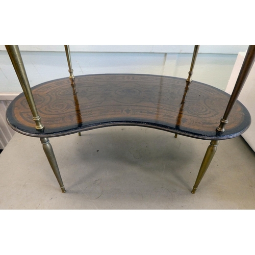 82 - An early 20thC overpainted mahogany kidney shaped three tier whatnot, elevated on tapered, brass sup... 