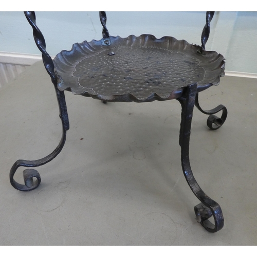 84 - An Art Nouveau inspired wrought iron framed and spot-hammered three tier brass tray cakestand  ... 