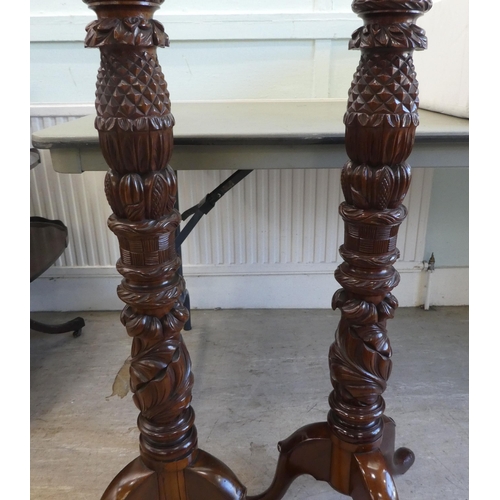 88 - A pair of modern carved mahogany torcheres, raised on tripod bases  57