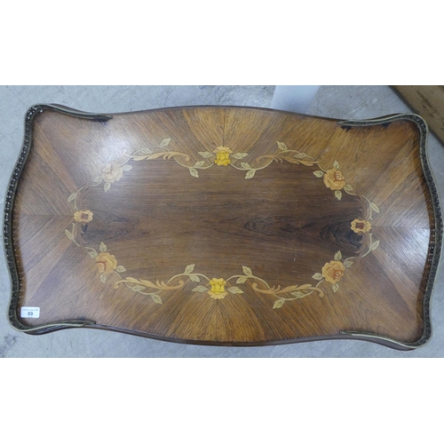 89 - A 20thC reproduction of a 19thC Italian inspired marquetry rosewood finished coffee table with a bra... 