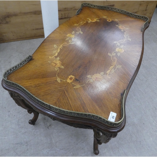 89 - A 20thC reproduction of a 19thC Italian inspired marquetry rosewood finished coffee table with a bra... 