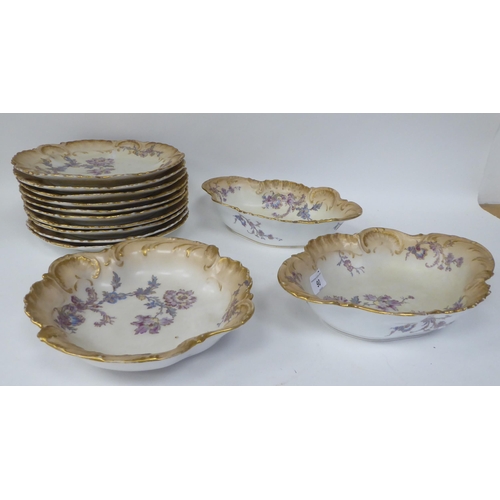 90 - Limoges porcelain tableware, decorated with pastel coloured flowers and gilt banding 