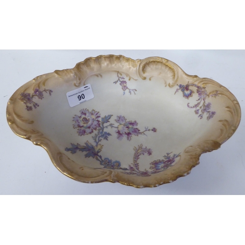 90 - Limoges porcelain tableware, decorated with pastel coloured flowers and gilt banding 