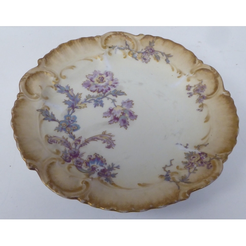 90 - Limoges porcelain tableware, decorated with pastel coloured flowers and gilt banding 