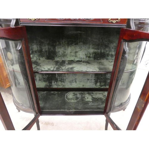 98 - An Edwardian mahogany credenza with a breakfront, bowed sides and glazed panels, enclosing two shelv... 