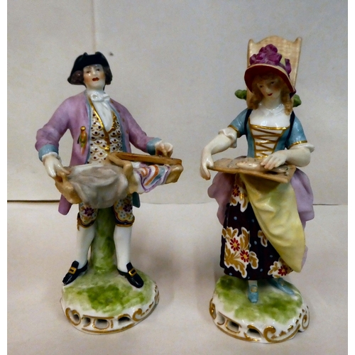 137 - A pair of 20thC Continental porcelain figures, a man and a woman, street vendors  7.5