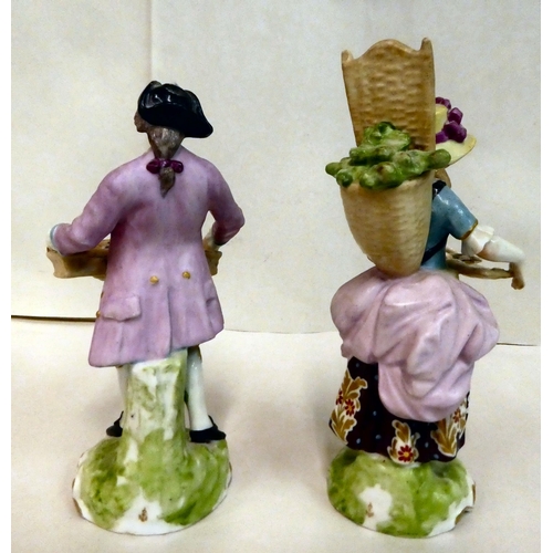 137 - A pair of 20thC Continental porcelain figures, a man and a woman, street vendors  7.5