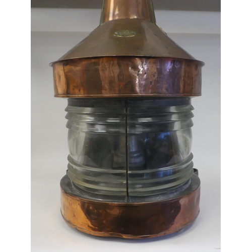 32 - An early 20thC copper and brass cased bulkhead lantern, comprising a covered chimney with a pendant ... 