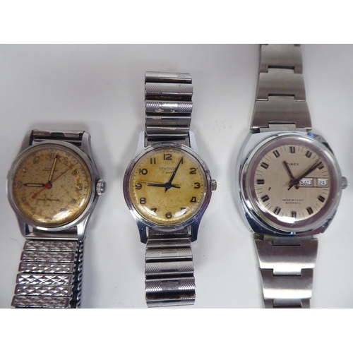 1 - Four stainless steel cased and strapped wristwatches; and another unstrapped