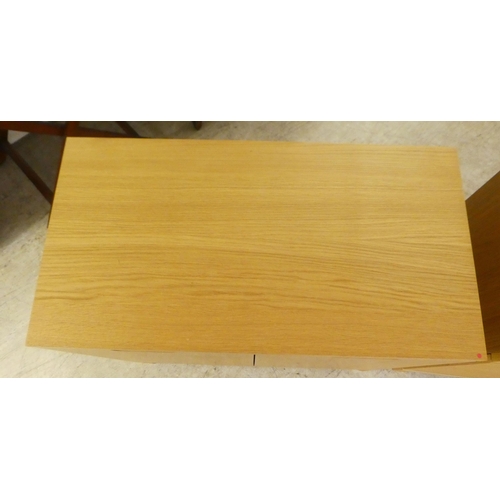 11 - Modern light oak finished furniture, viz. a three drawer dressing chest, on a plinth  29