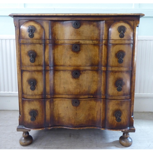 103 - An early 20thC Continental walnut moulded block front chest, comprising four graduated long drawers ... 