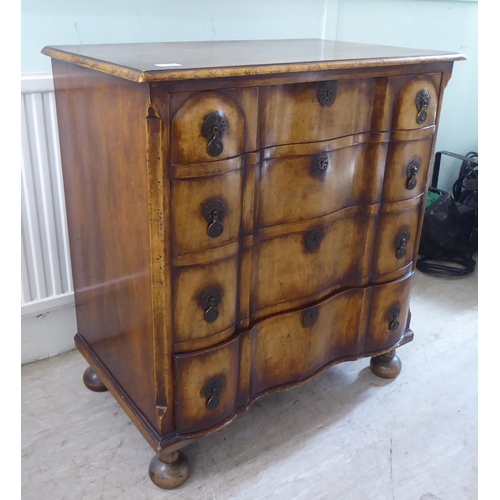 103 - An early 20thC Continental walnut moulded block front chest, comprising four graduated long drawers ... 