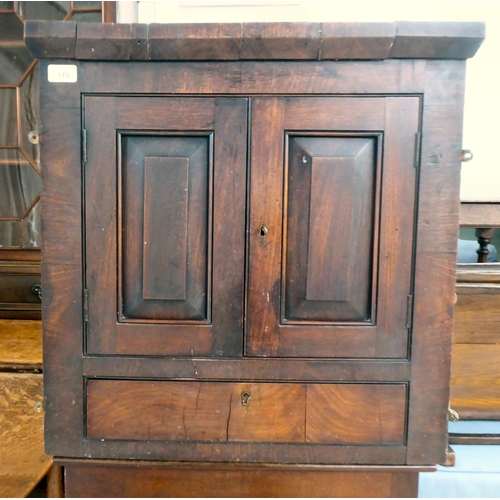 115 - An early 19thC Georgian mahogany hanging corner cupboard with two fielded panelled doors, over a bas... 