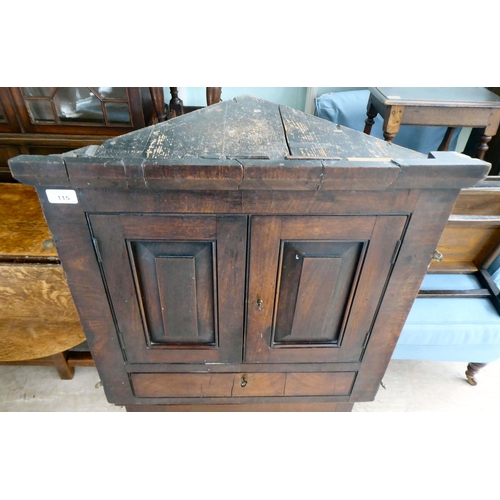 115 - An early 19thC Georgian mahogany hanging corner cupboard with two fielded panelled doors, over a bas... 