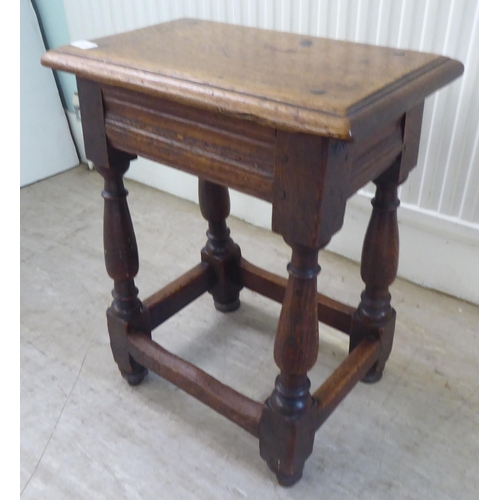 119 - An 18thC style, rustic oak joint stool with a dowelled top, over a vase turned and block underframe