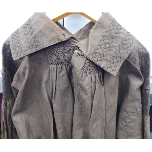 121 - A Continental artisan's brown calico pleated smock with simple decoration to the colour