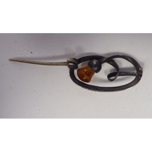 124 - A Charles Horner silver wire thistle brooch, set with an amber coloured stone