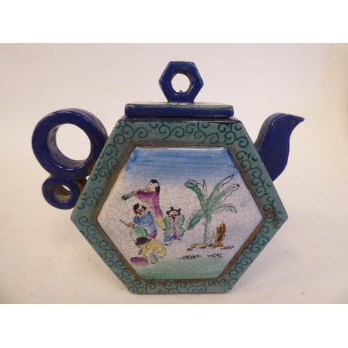 125 - A Chinese Yixing porcelain teapot of hexagonal form with a stubby double ring handle, cover and knop... 